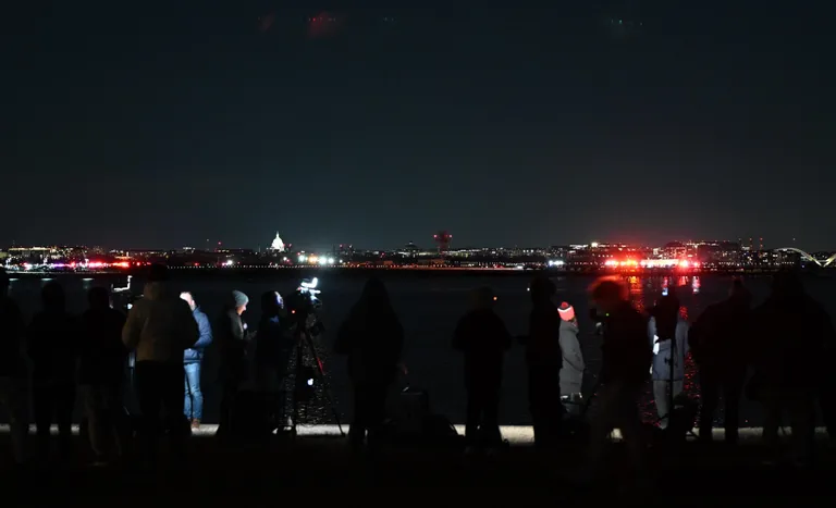 Press members work near the scene area after a regional plane collided in midair with a military helicopter and crashed into the Potomac River in Washington, D.C., on January 30, 2025 | Source: Getty Images